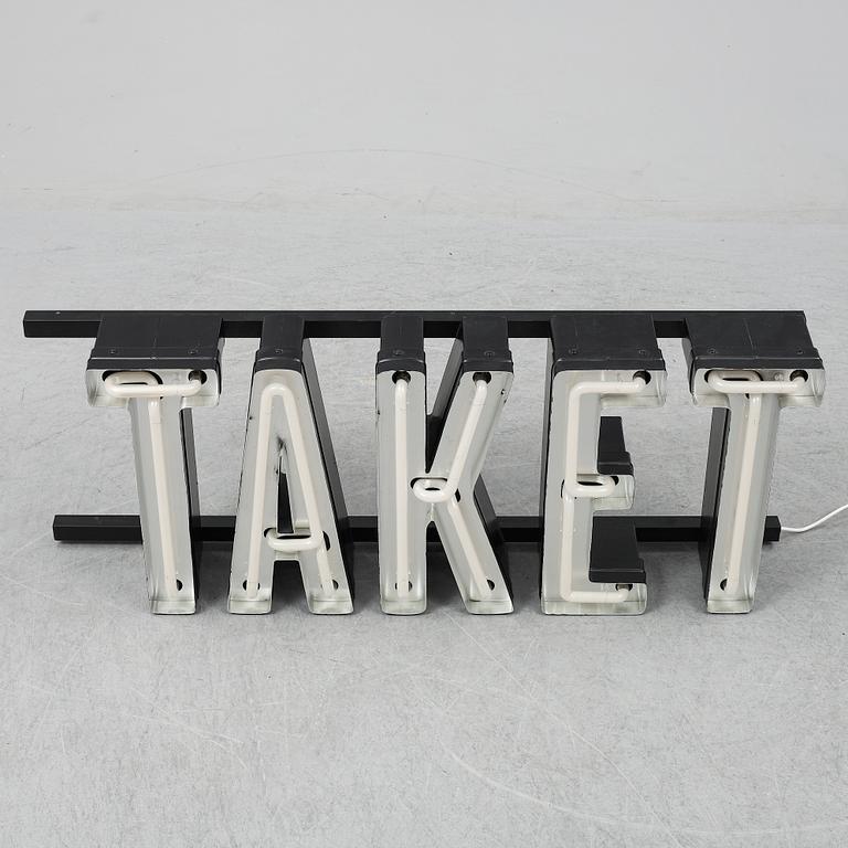 A neon sign "TAKET", late 20th century/21st century.