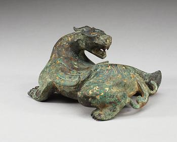 An archaistic bronze figure of a mythological beast.