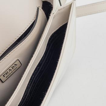 Prada, A white spazzolato leather bag.