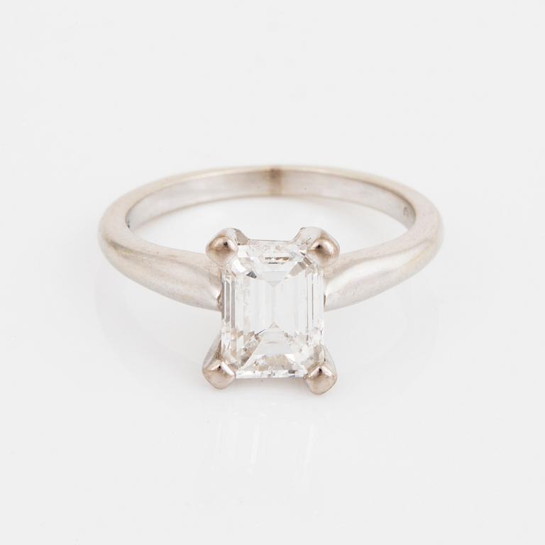 A solitiare emerald-cut diamond ring.