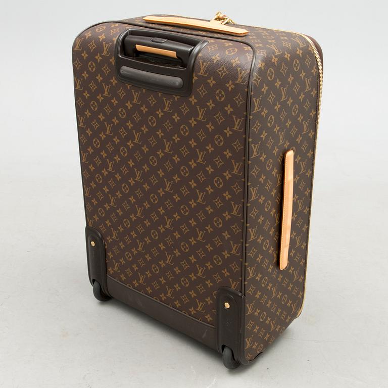 A Monogram Canvas Pégase 65 Suitcase with a Protective Cover.