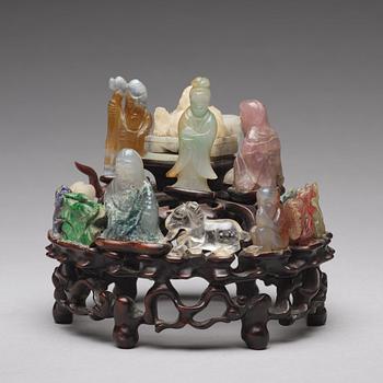 An arrangement of stone sculptures on a wooden stand, China 20th Century.