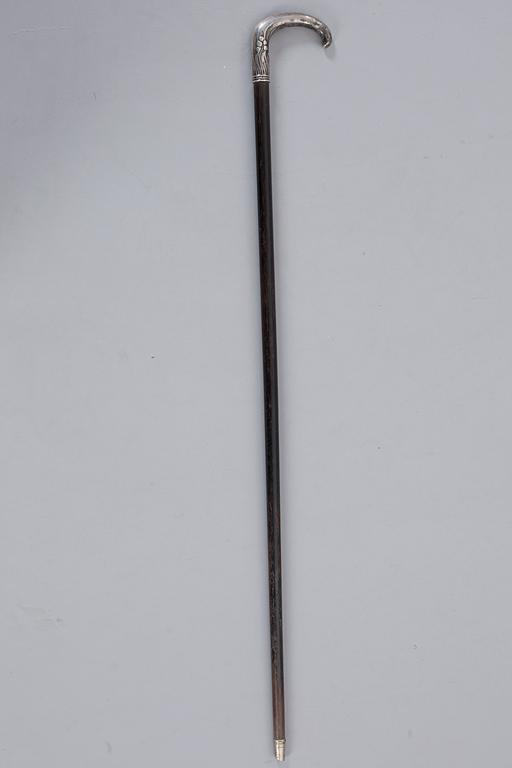 A CANE WITH SILVER MOUNTING, 1910.