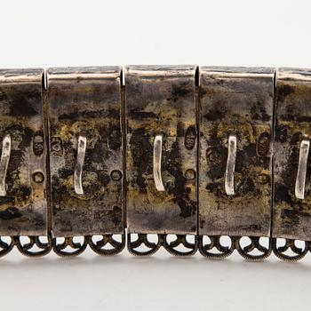 A Caucasian parcel-gilt costume belt with niello decor, 1908-26.