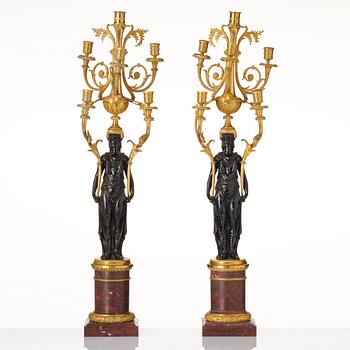 A pair of Louis XVI ormolu and patinated bronze six-branch candelabra attributed to François Rémond, late 18th century.