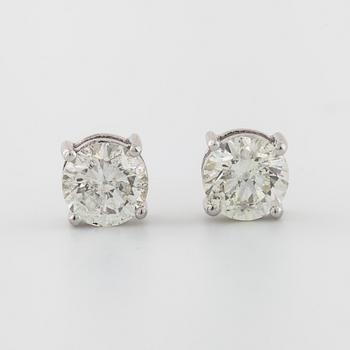 A pair of brilliant cut diamond earrings.