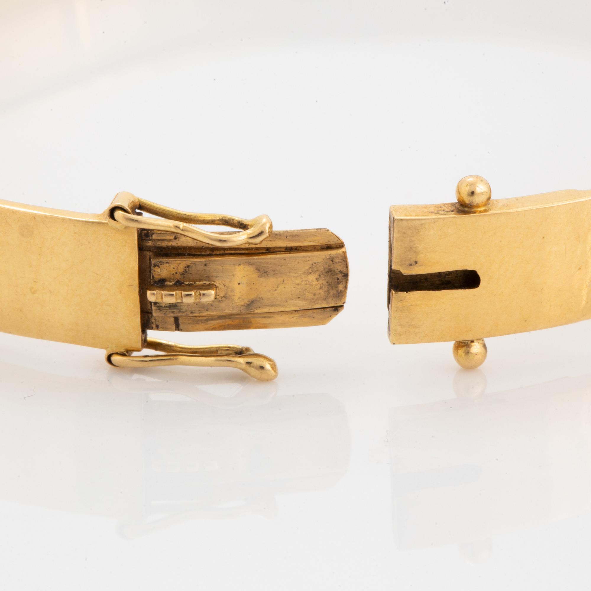 18K gold bangle and white synthetic stones.