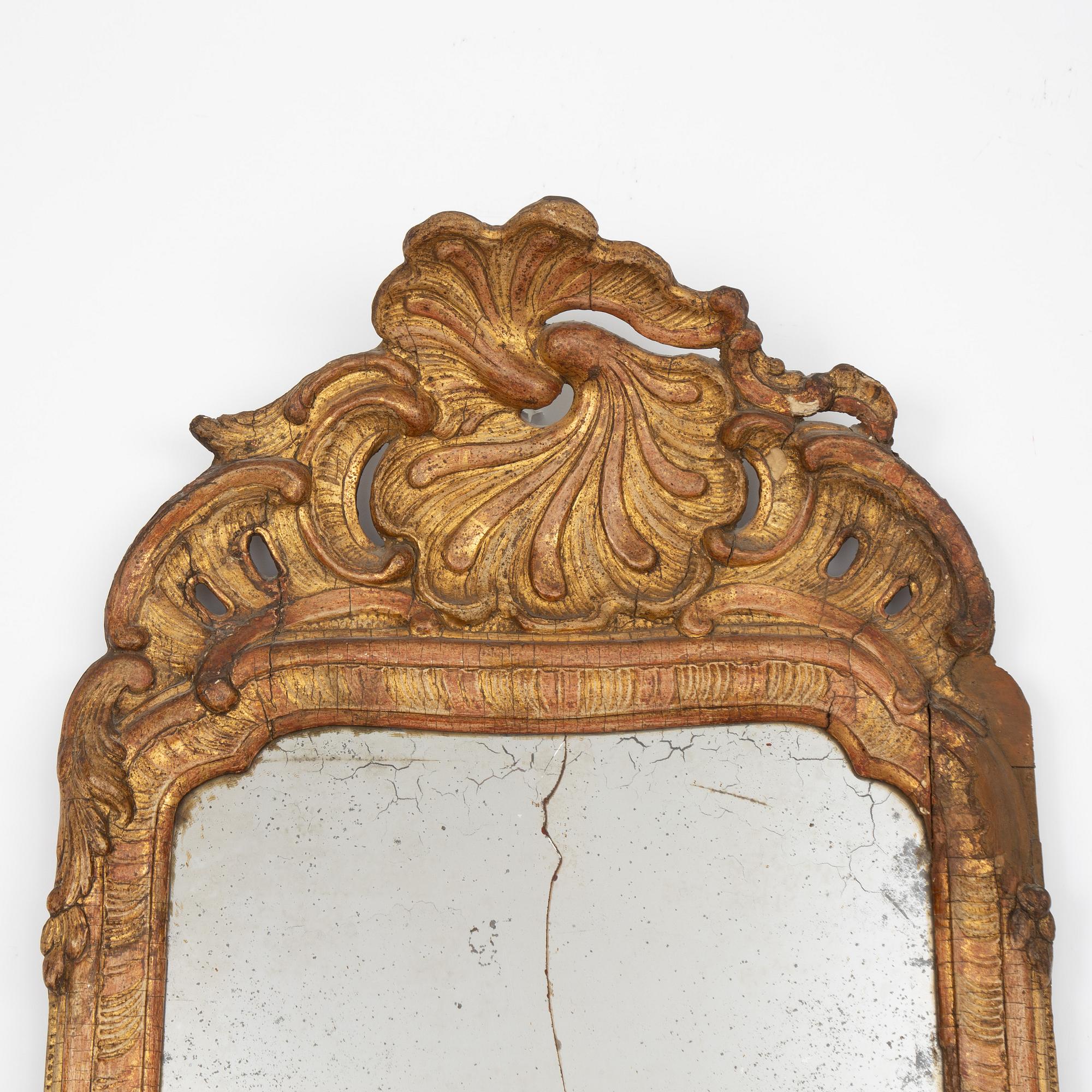 A Swedish rococo giltwood mirror in the manner of E. Göbel, Stockholm, later part 18th century.