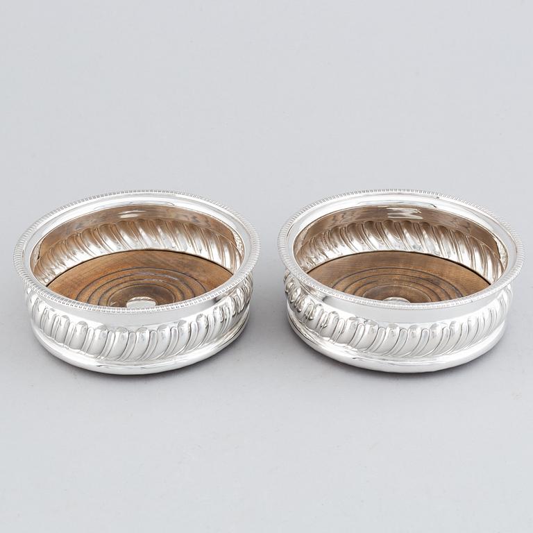 A pair of silver plated coasters.