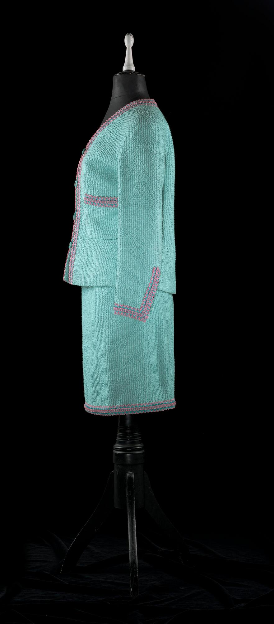 A 21 th cent green bouclé two-pieces costume by Chanel.