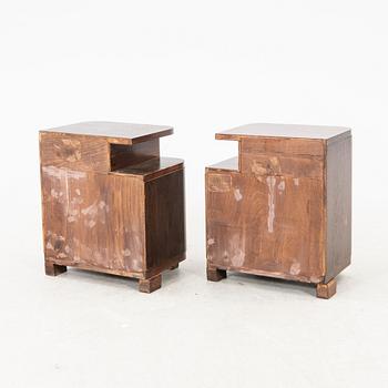 A pair of stained wood bedside tables from the first half of the 20th century.
