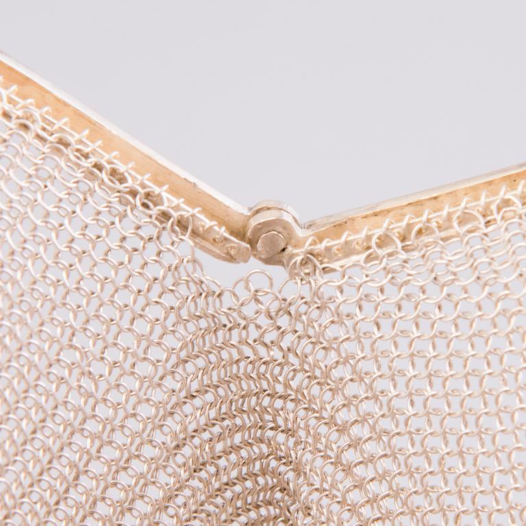 Two silver evening bags and a silver mirror, 1920s-1940s.