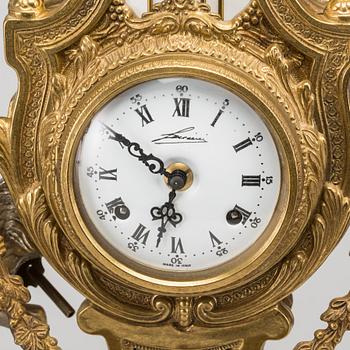 A LOUIS XVI STYLE GILT-BRASS CLOCK GRANITURE. Italy, SECOND HALF OF 20TH CENTURY.