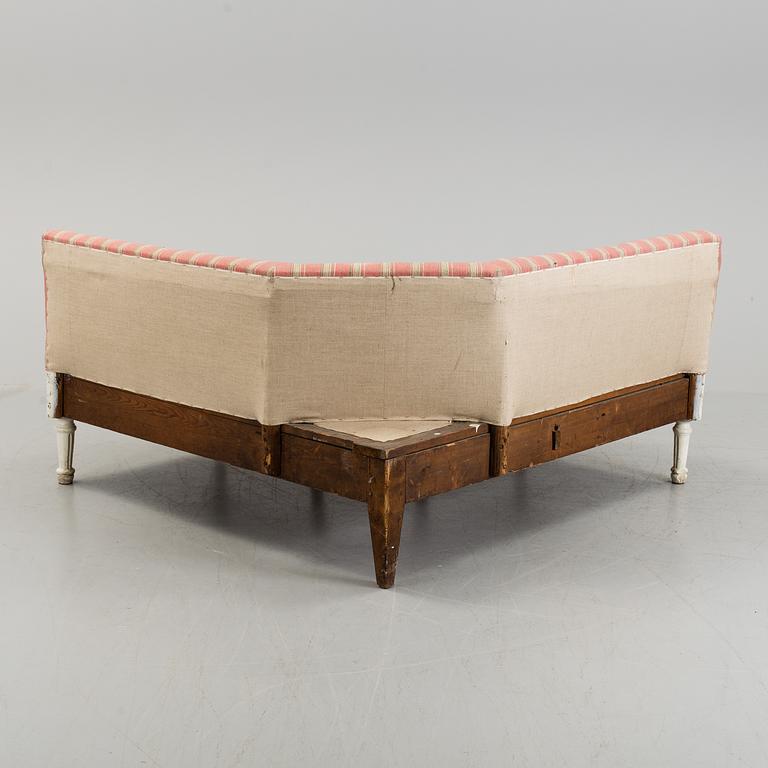 An early 19th century corner sofa.