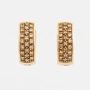 18K gold and brilliant cut diamond hoop earrings.