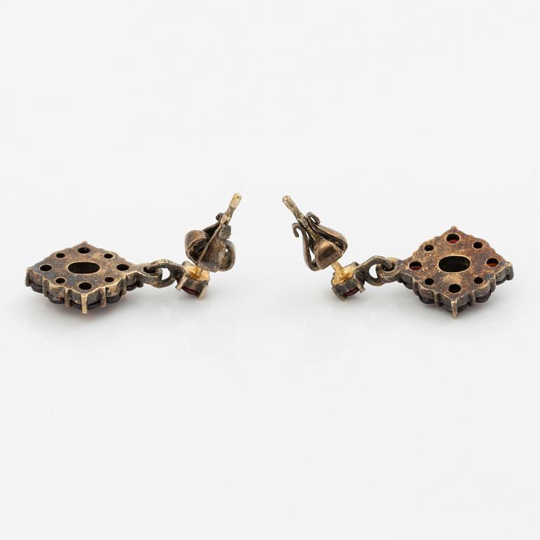 Pendant and a pair of earrings, gilt metal with garnets.