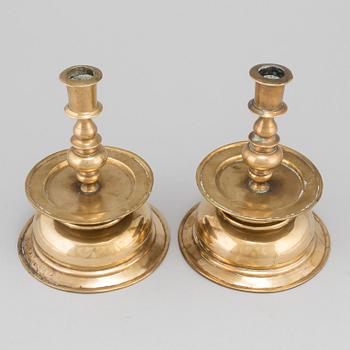 A pair of 17th century brass candlesticks.