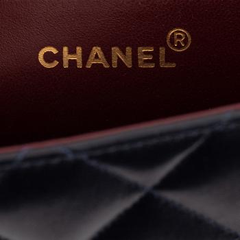 Chanel a black leather and gold hardware 'Maxi flapbag', 1991-1994.