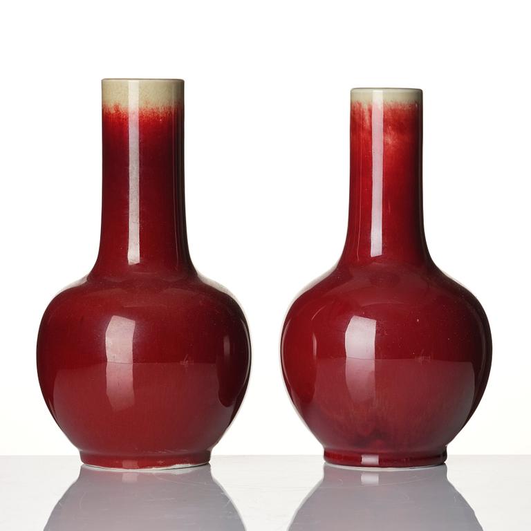 A set of two sang de boef glazed vases, late Qing dynasty, circa 1900.