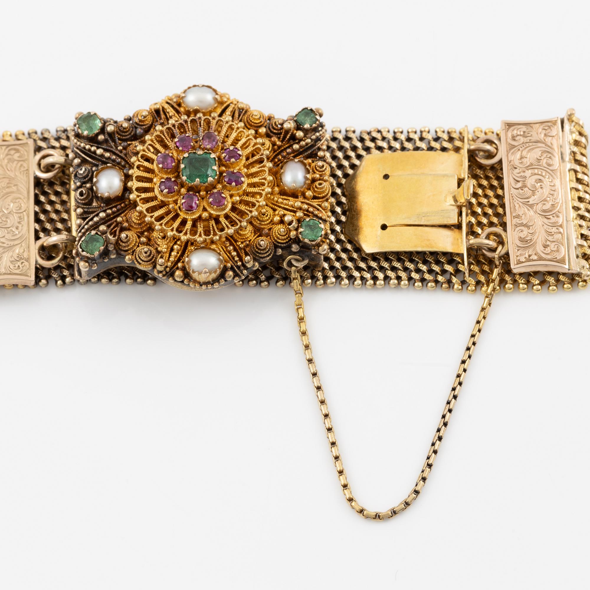 Bracelet in gold with pearls, emeralds, and rubies.