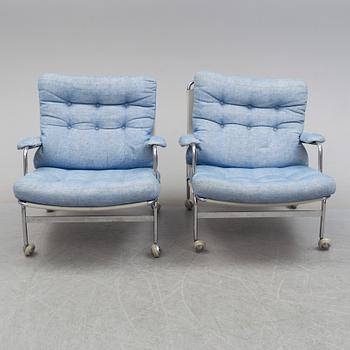 A pair of easy chairs with stool by Bruno Mathsson, DUX, late 20th century.