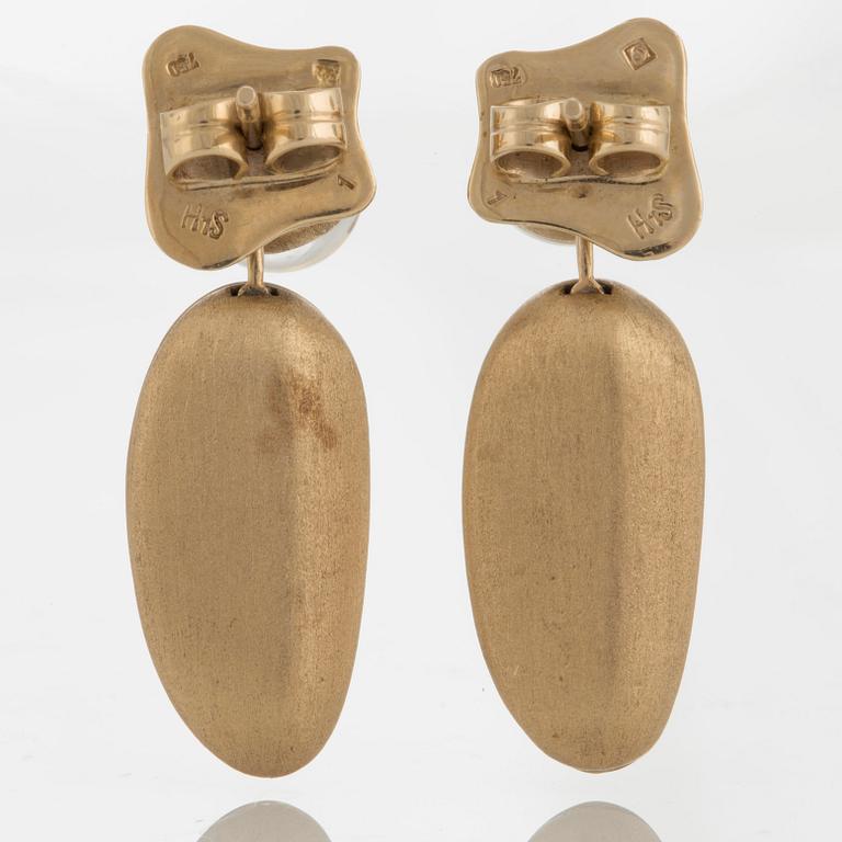 A pair of 18K gold H Stern earrings set with cabochon-cut rock crystal.