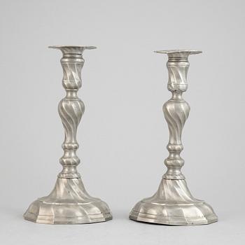 A pair of rococo style pewter candlesticks, 19th Century.
