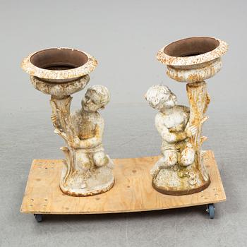 An end of the 20th Century pair of cast iron flower pots.