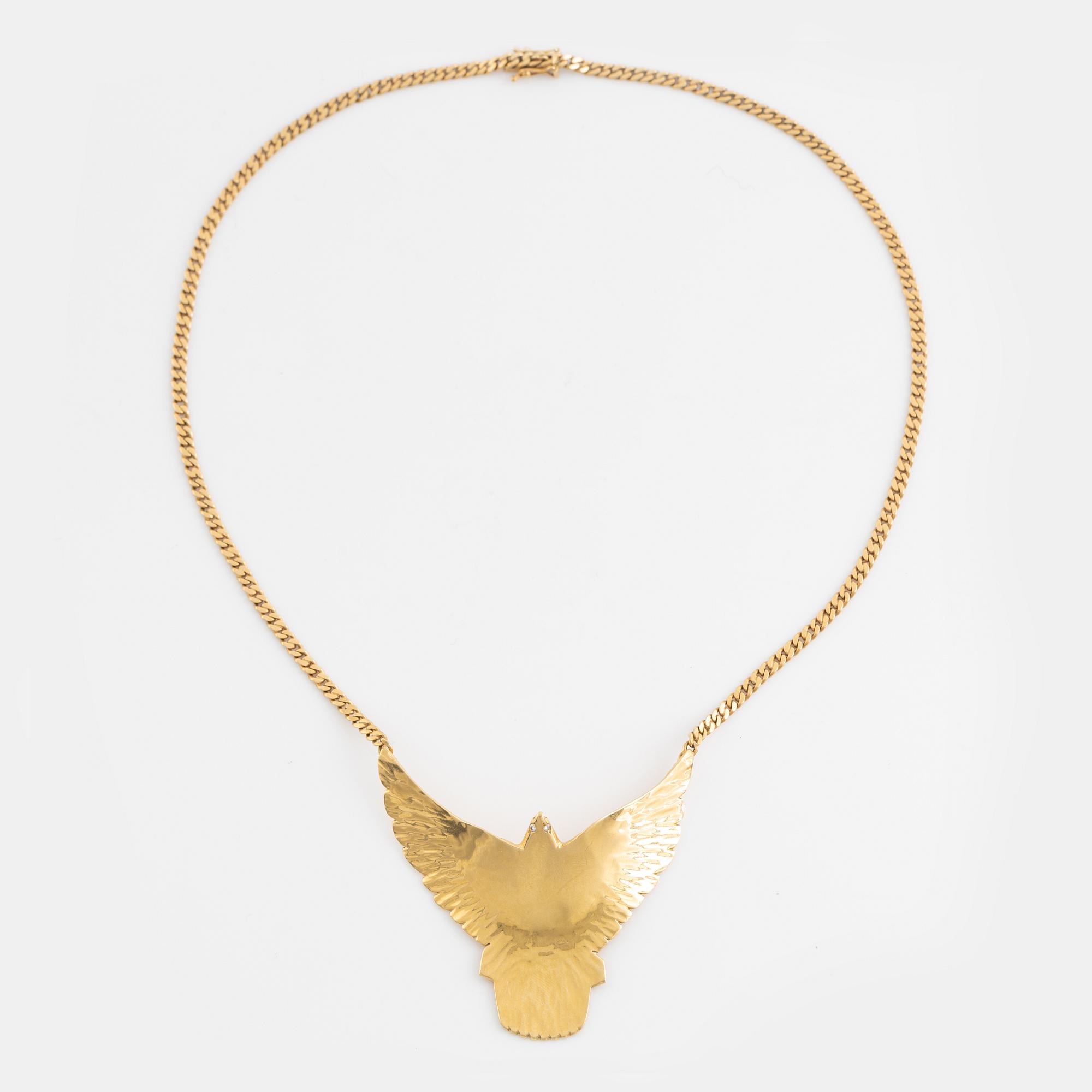 Gold and brilliant cut diamond bird necklace.