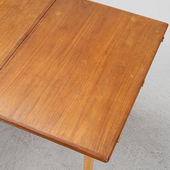 A 1960's teak and rosewood veneered dining table.