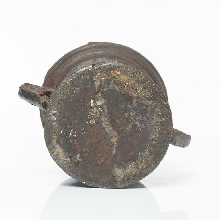 A cast-iron mortar and pestle of renaissance-type, 17th century.