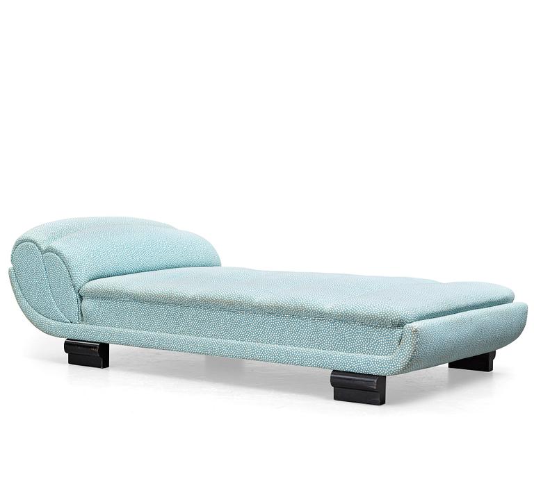 ART DÉCO, an upholstered daybed on shaped black lacquered wooden legs, 1920's-30's.