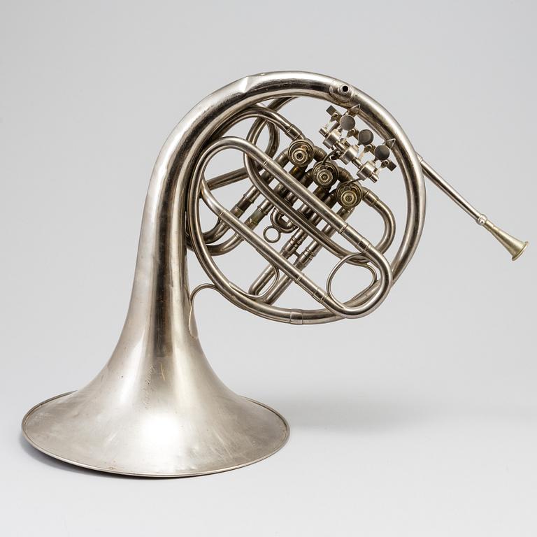 A metal french horn, probably 1936.