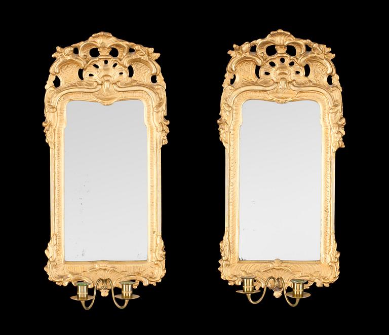 A pair of Swedish Rococo 18th century two-light girandole mirrors.