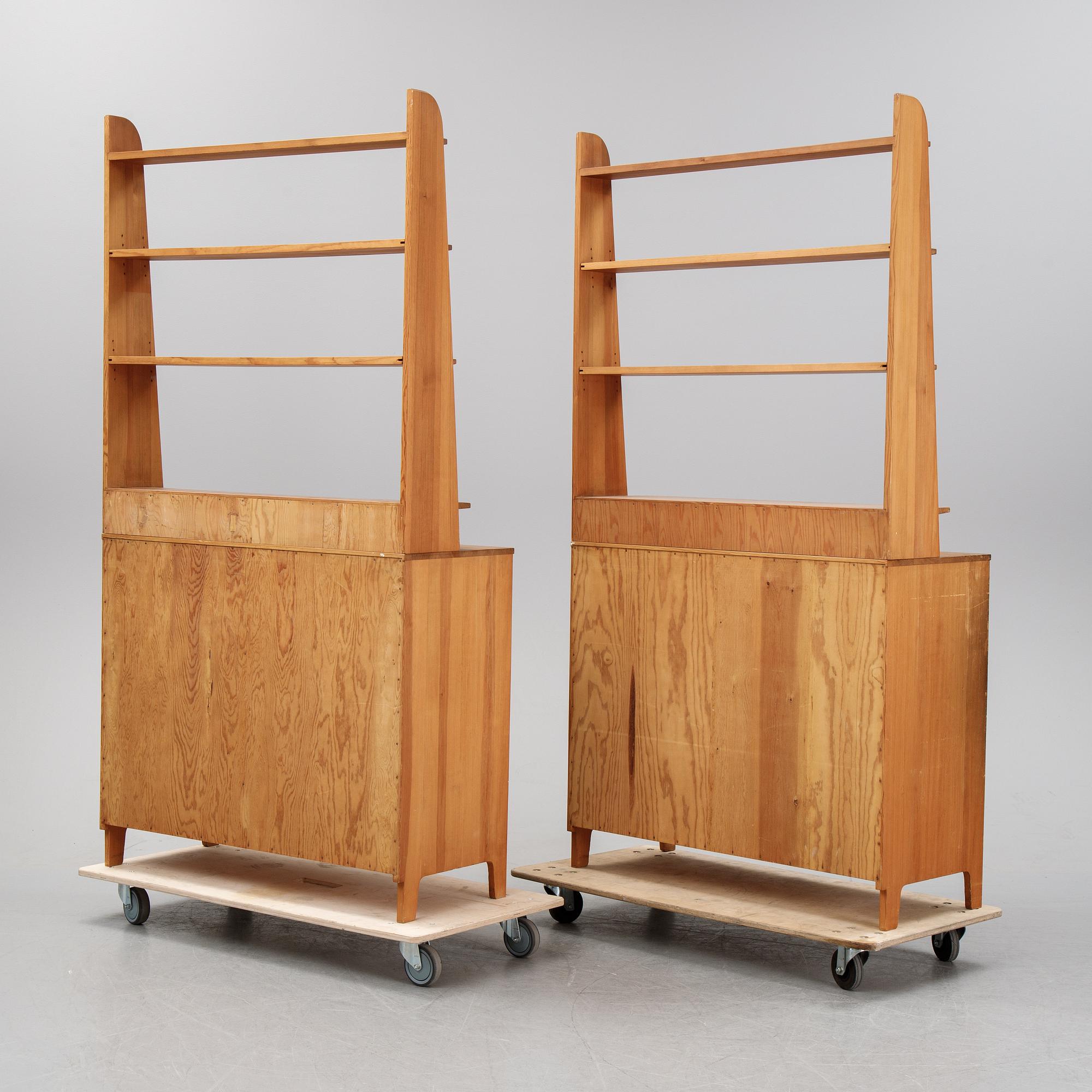 A pair of pine cupboards with shelves by Carl Malmsten.