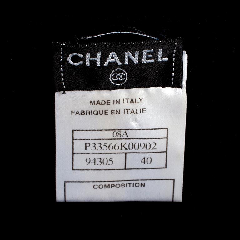 CHANEL, a black cashmere carding and a bouclé skirt.