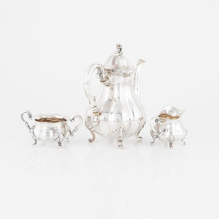 A Rococo-Style Sterling Silver Coffee Pot, Creamer and Sugar Bowl, Swedish import marks.
