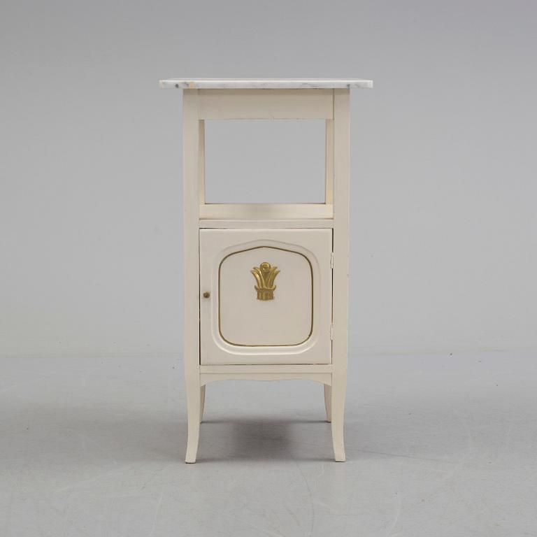 A early bedside table with marble top.