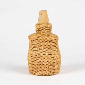 A root and glass bottle with birch stopper.