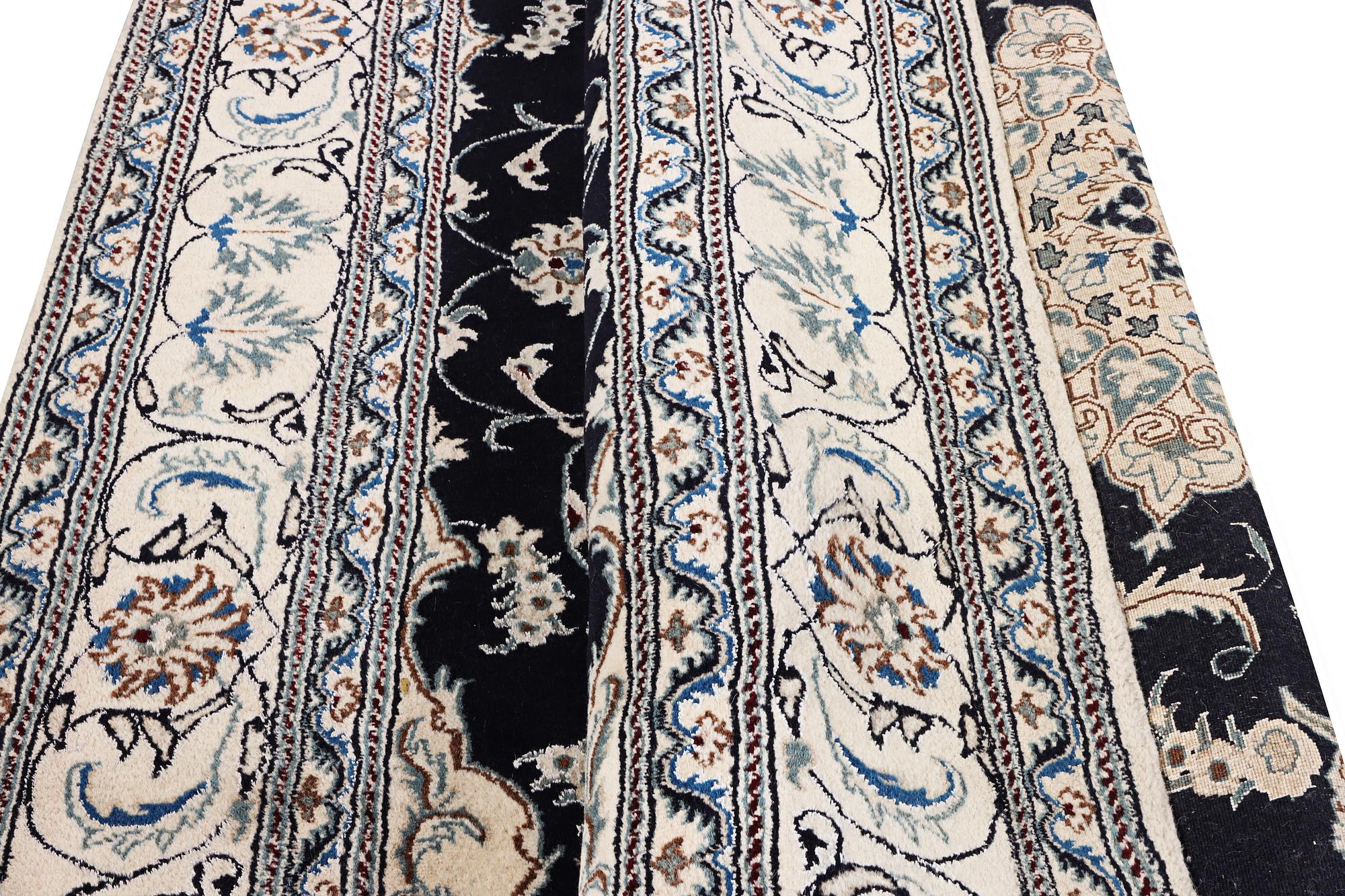 A Nain carpet, part silk, c. 303 x 200 cm.