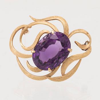 An 18K gold brooch set with an oval faceted amethyst.