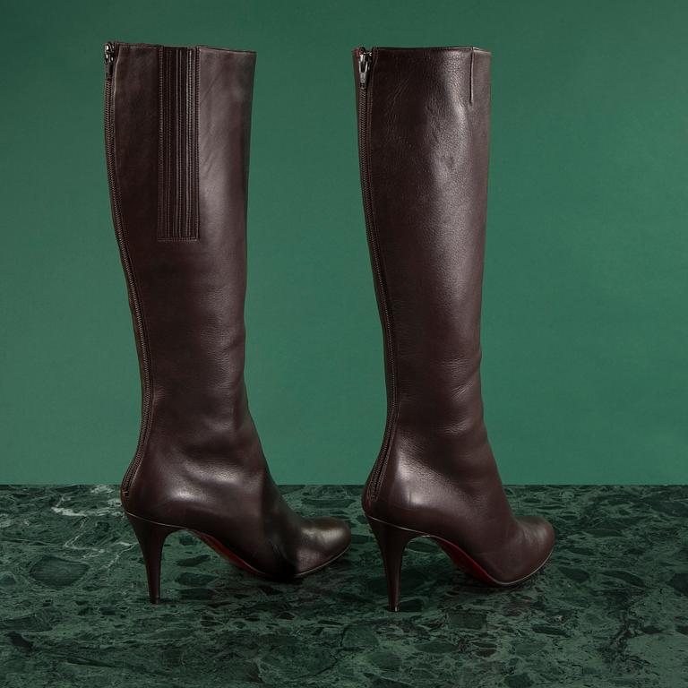 A pair of brown leather boots by Christian Louboutin, size 41 1/2.