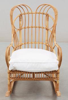 A Josef Frank ratten and beech rocking chair, Svenskt Tenn, model 1077, 1940's-50's.