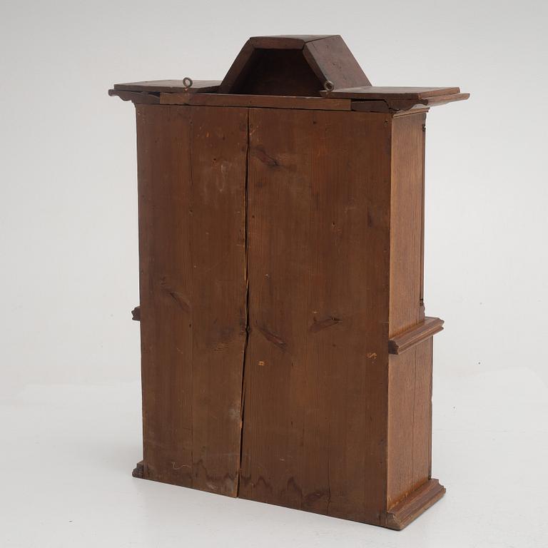 A wall cabinet, dated 1765.