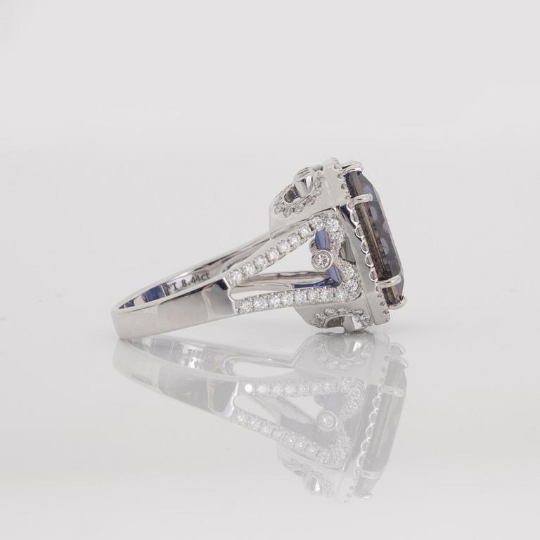 An iolite, 8.44 cts, and brilliant-cut, 1.11 cts in total, diamond ring.