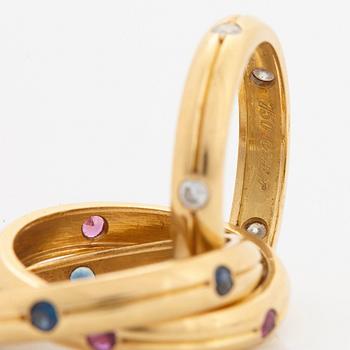 A Cartier "Trinity" ring in 18K gold set with round brilliant-cut diamonds, rubies and sapphires.