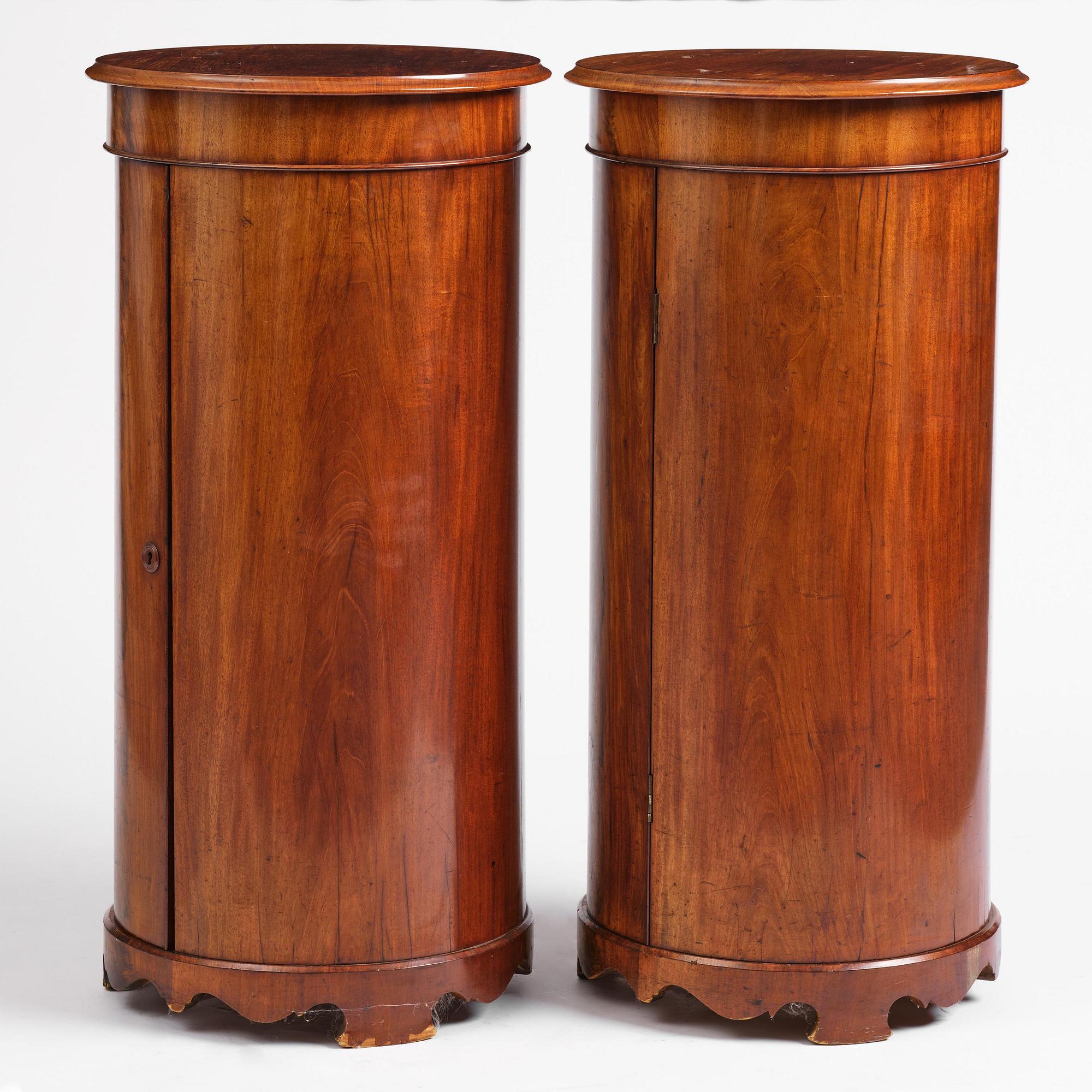 A pair of late Empire mahogany column cabinets, mid 19th Century.