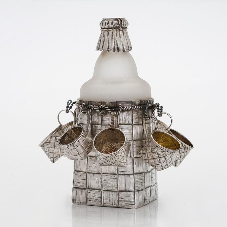 A silver and glass bottle with eight silver charka, maker marks of Pyotr Yermolajevich Davidov, Saint Petersburg, 1884.