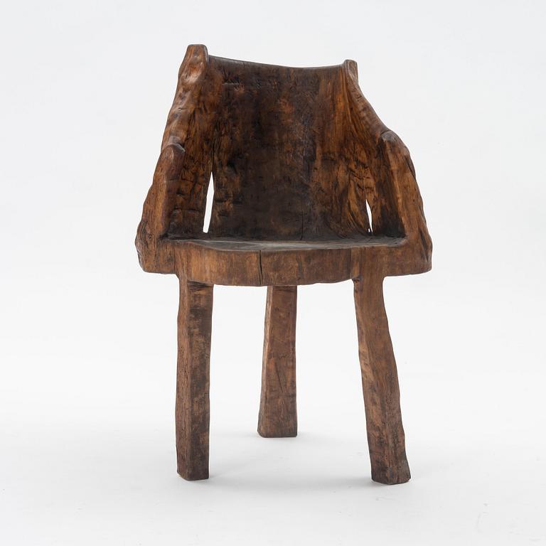 A one piece carved armchair, Sweden early 20th century.