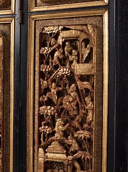 A set of four framed wooden panels, Qing dynasty, 19th Century.